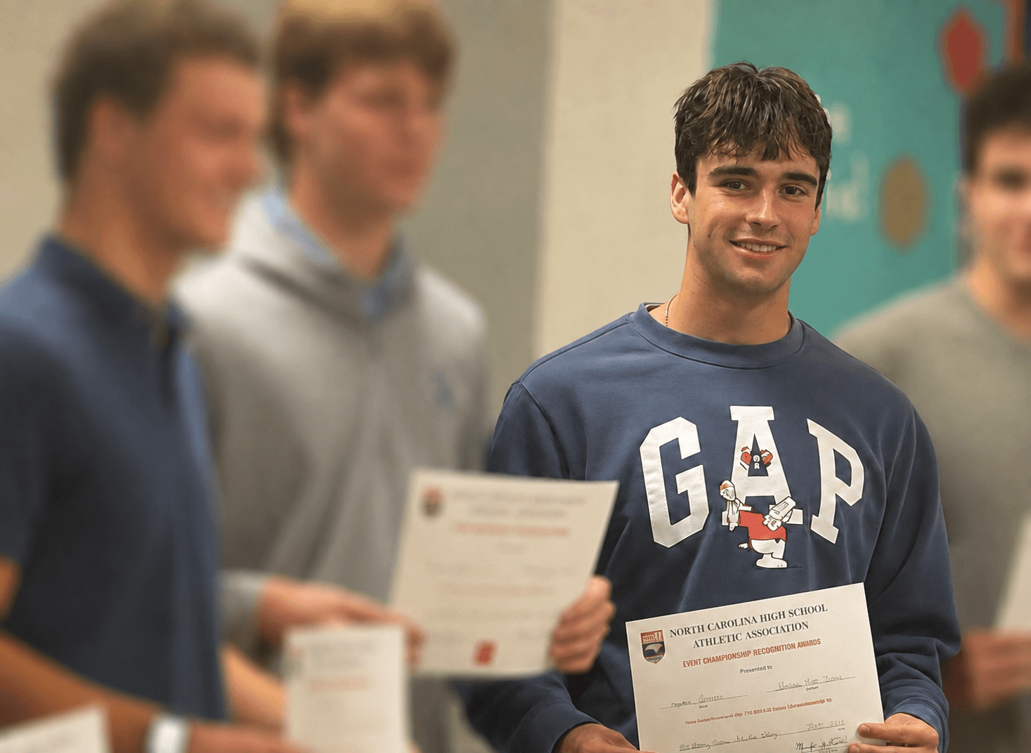 Ayden holding his North Carolina state championship participation award
